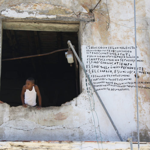 Photo of a young boy in a window in Cuba